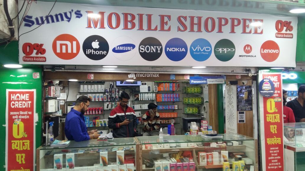 The older Sunny's Mobile Shoppee signboard with brand logos